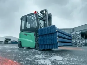 EDiA-gaffeltruck fra Logisnext Denmark transporterer reolsektioner udendørs i vinterlys